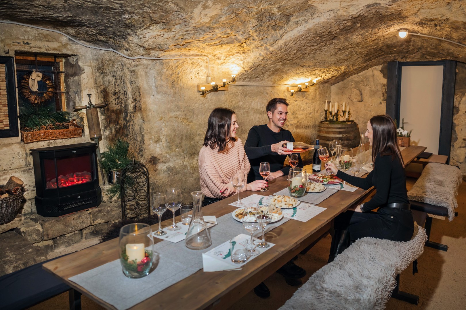 Friends drink wine at the Christmas table