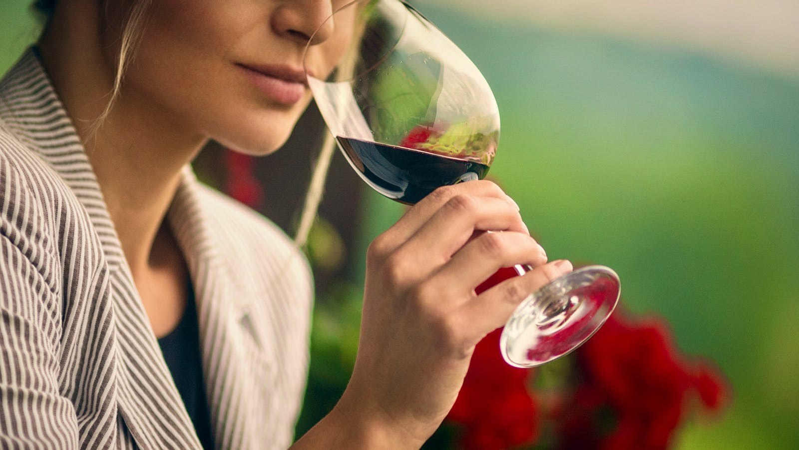 Woman sniffs red wine