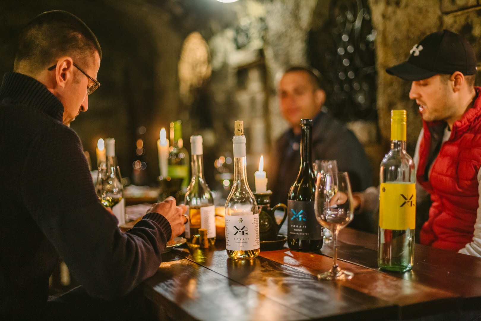 Friends drinking Tokaj wines in a cellar
